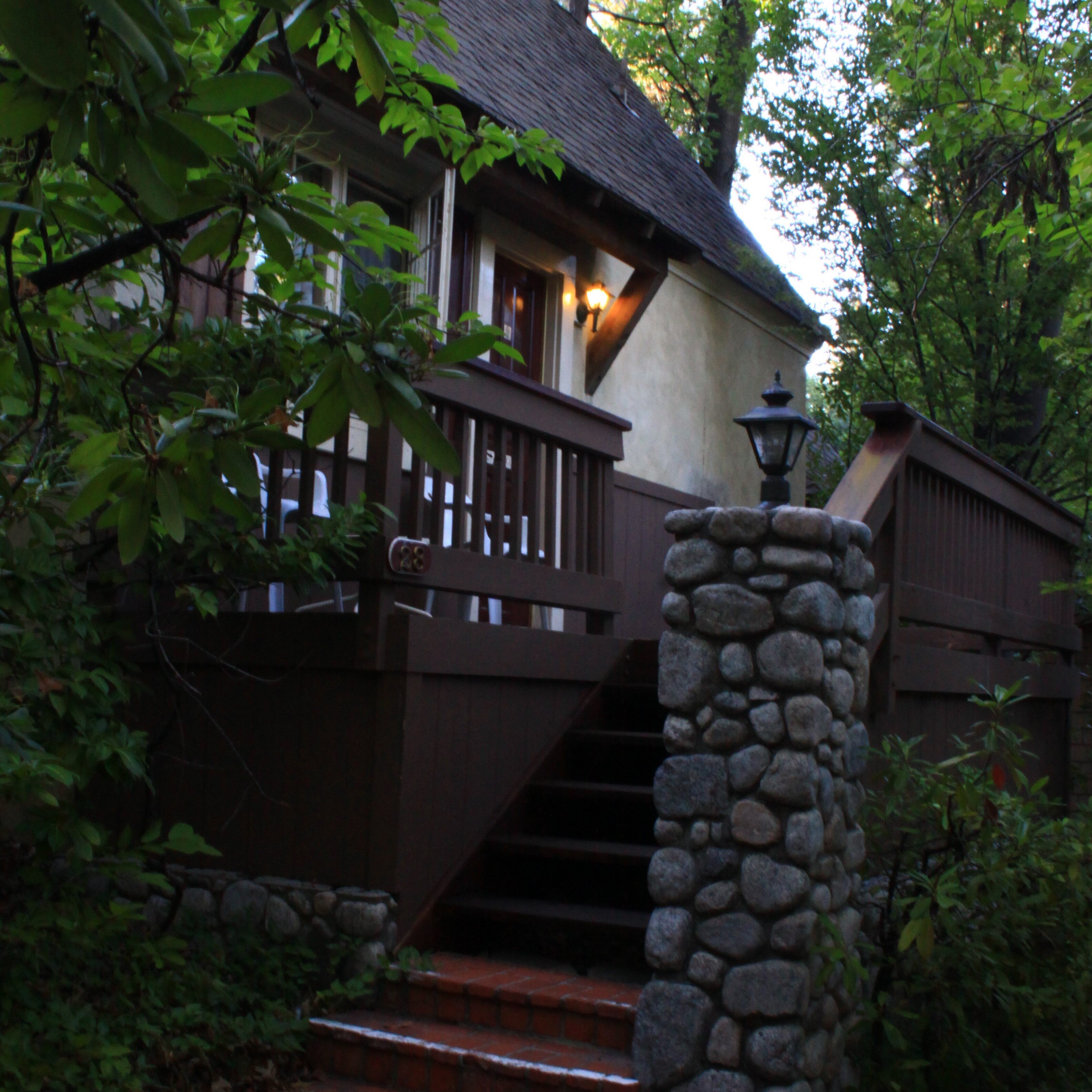 A house with a stone pillar and stairs